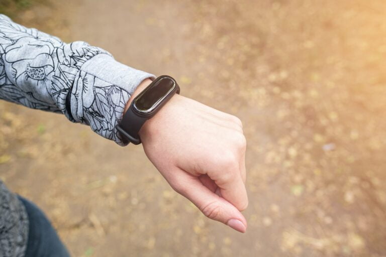 Fitness tracker on woman's wrist, sport activity monitor concept