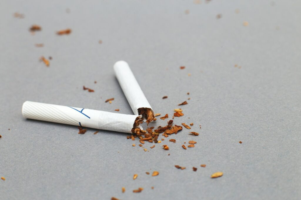 broken cigarette on a gray background close. stop smoking concept